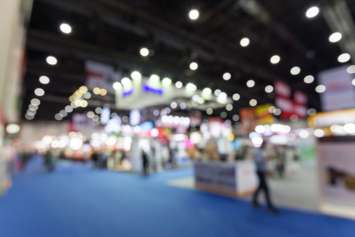 A blurred view of the main floor of a tradeshow.