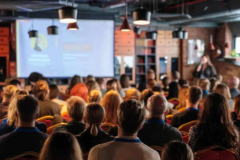 A group of about 40 people attending a seminar.