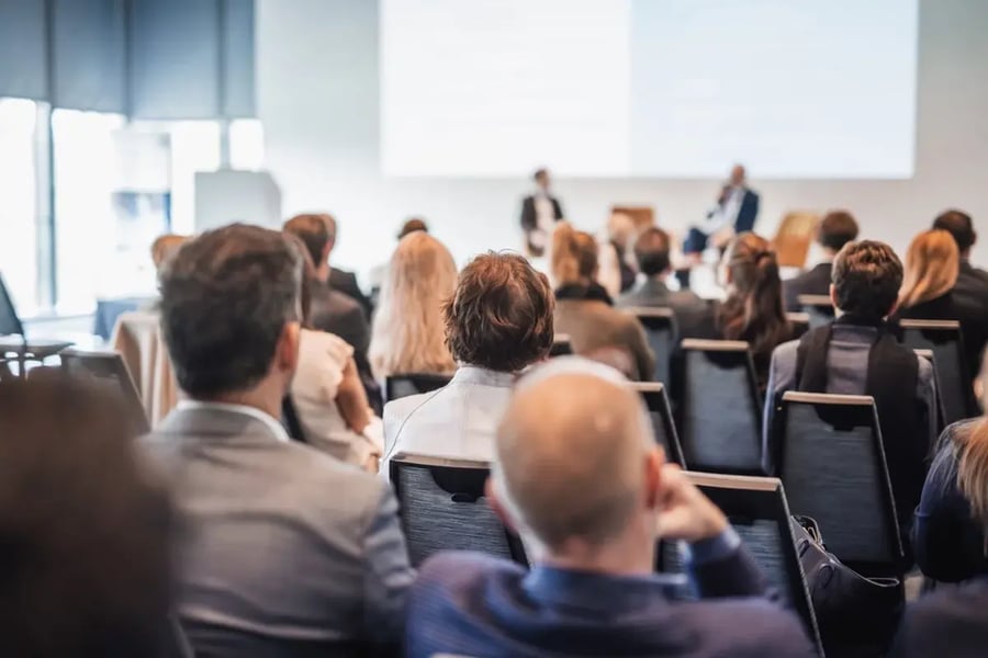 A panel discussion in a medium meeting room.