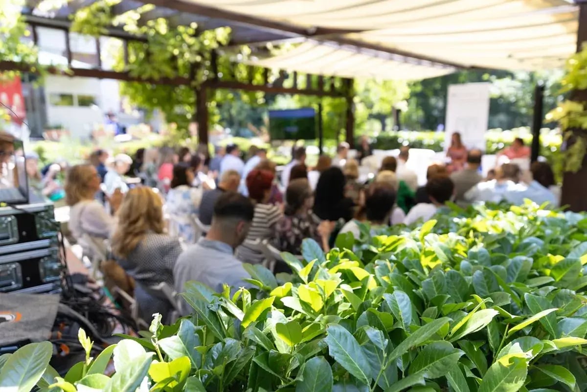 A speaking event under a pavilion.