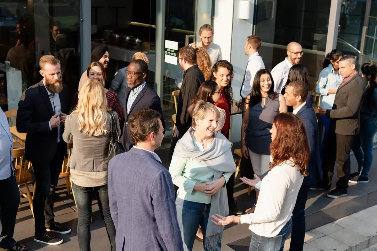 An outdoor event with people in business clothes.