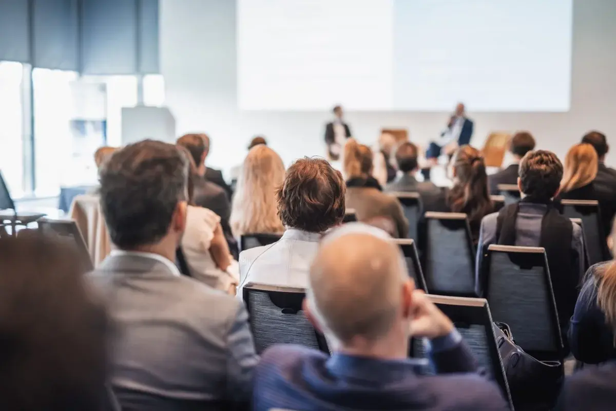 A panel discussion in a medium meeting room.